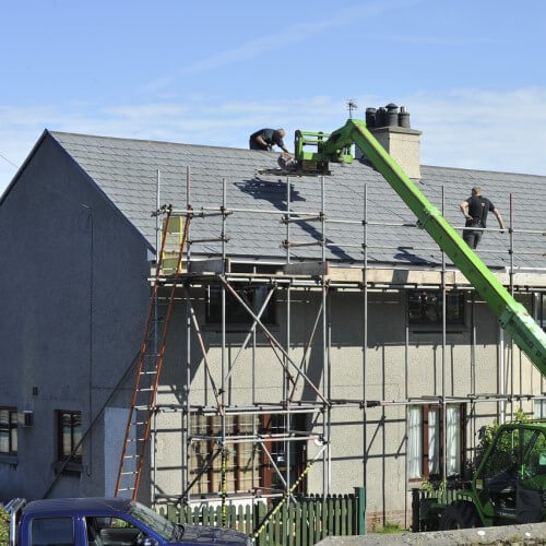 Scaffolding being placed to reinforce a roof for a construction job